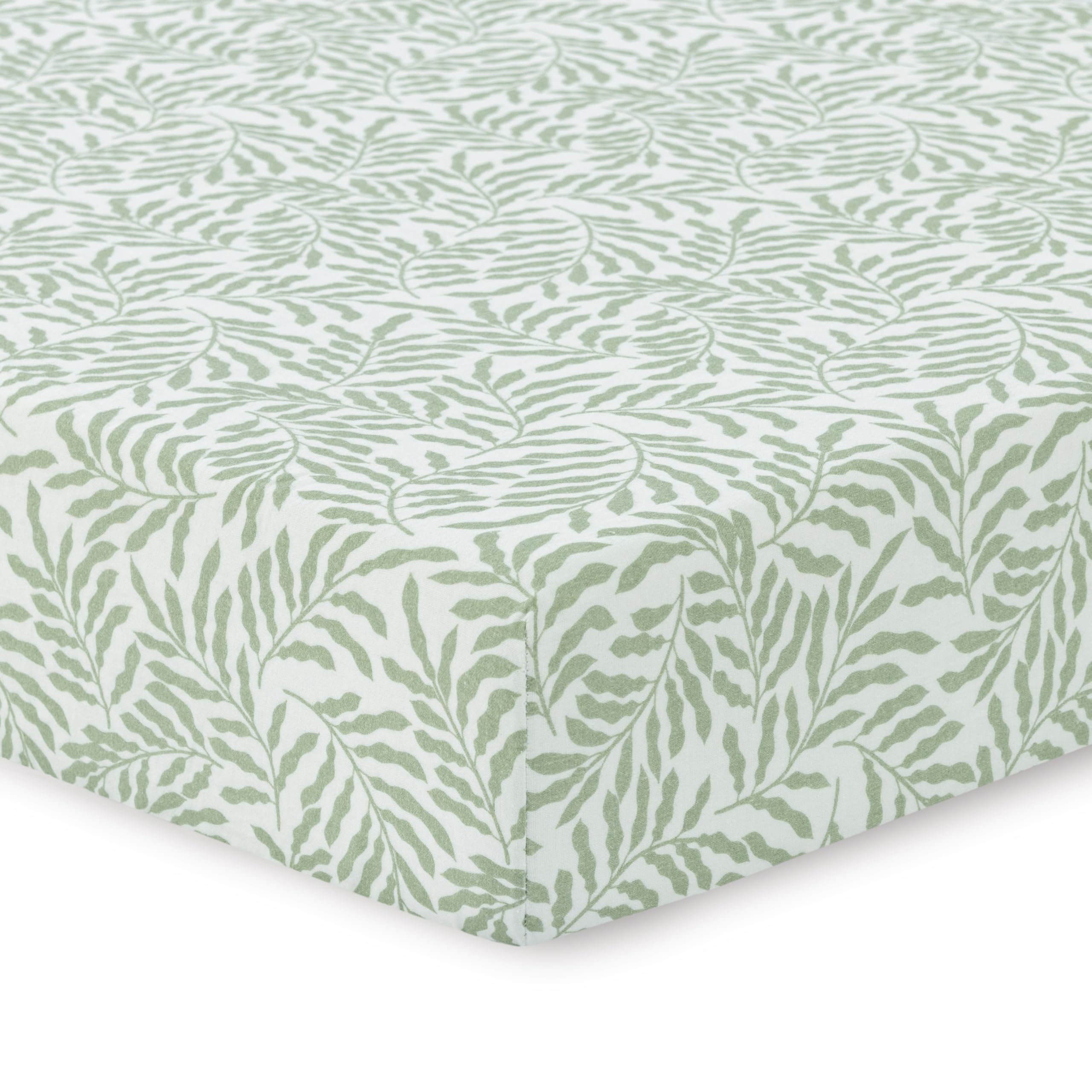 Dreamology leaves crib sheet on a crib showing cozy breathable muslin fabric
