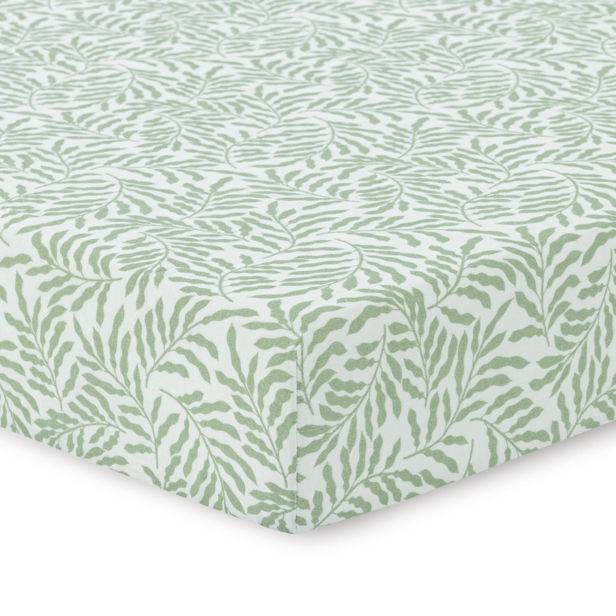 Dreamology leaves crib sheet on a crib showing cozy breathable muslin fabric