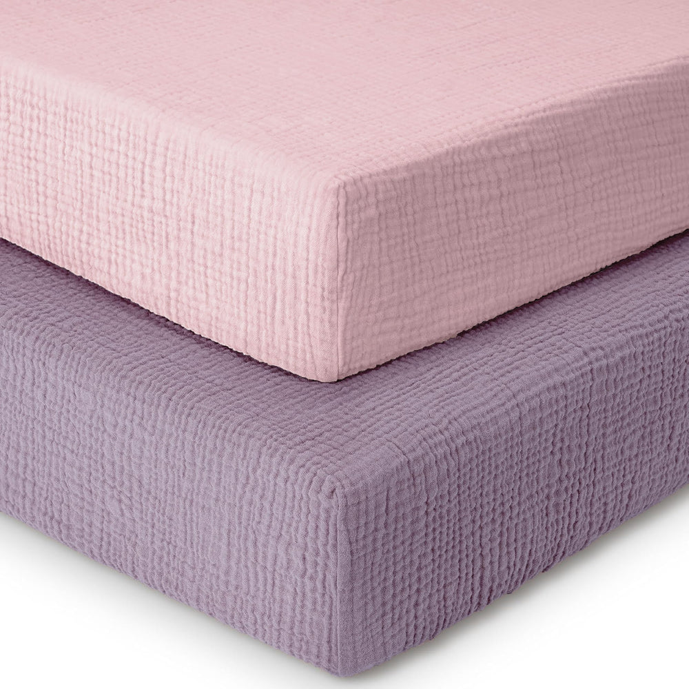 Dreamology muslin crib sheet 2-pack on a standard crib mattress, showing a snug fit.