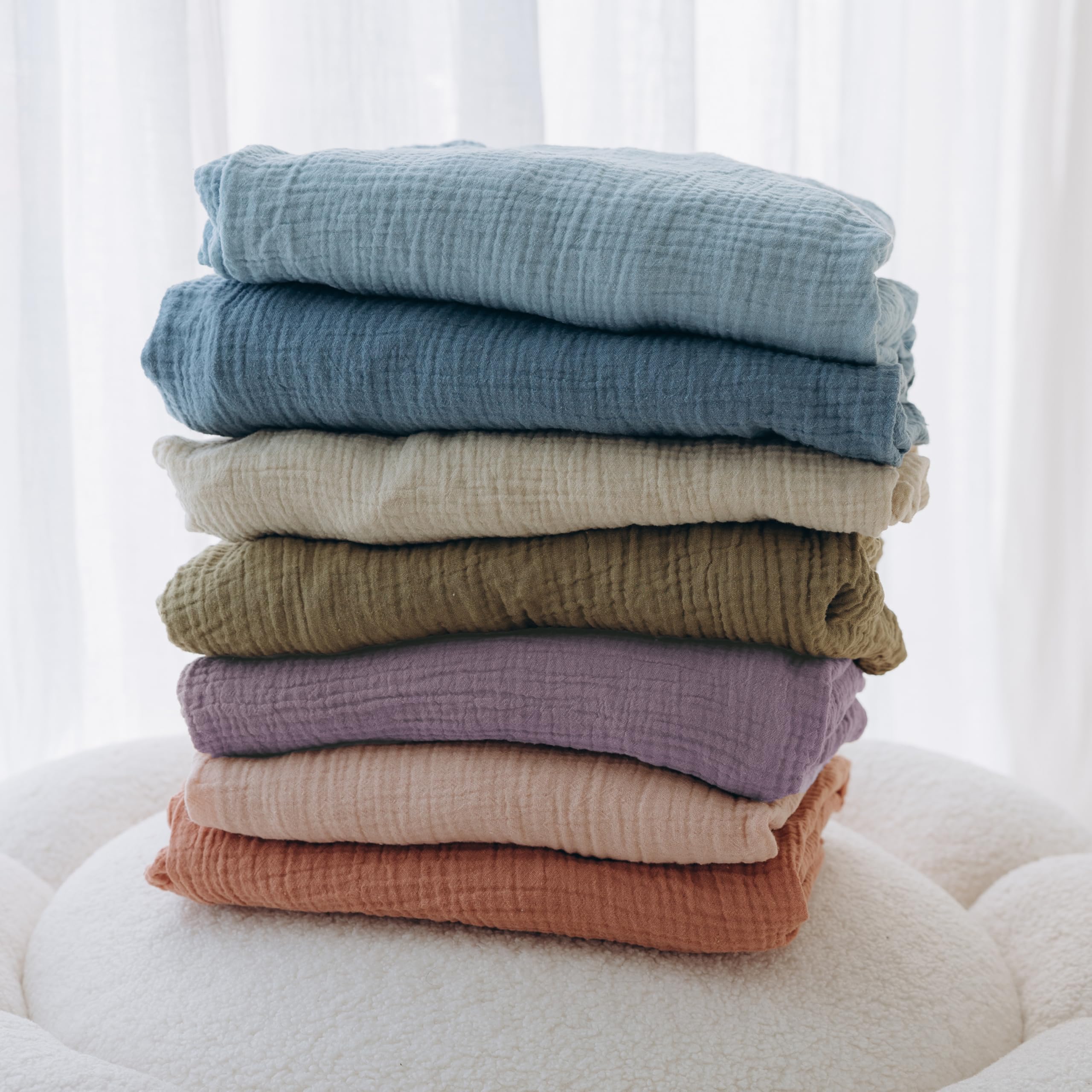 Dreamology muslin crib sheet color varieties in purple and pink.