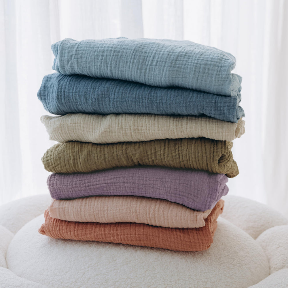 Dreamology muslin crib sheet color varieties in purple and pink.