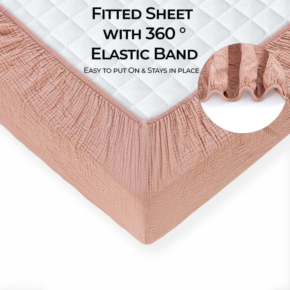Dreamology muslin crib sheets close-up elastic edge for secure fit.
