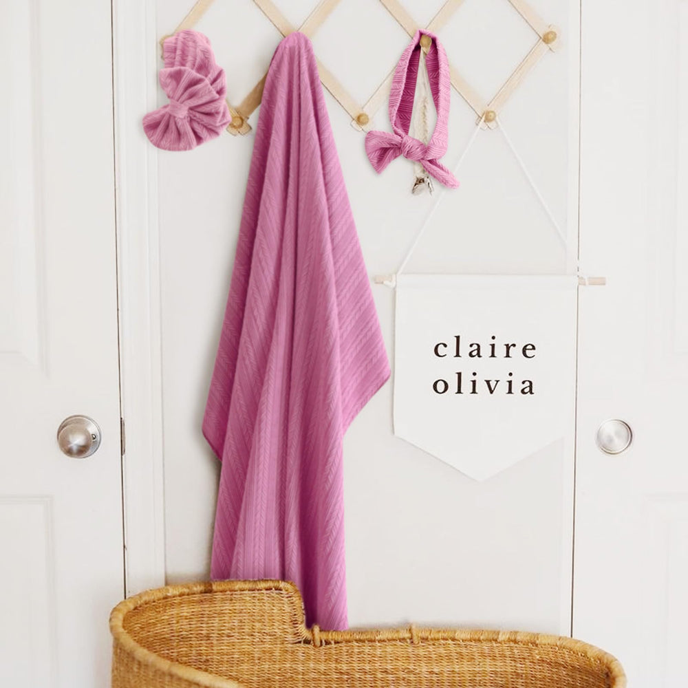 DRESHOW BQUBO baby wrapped securely in swaddle blanket