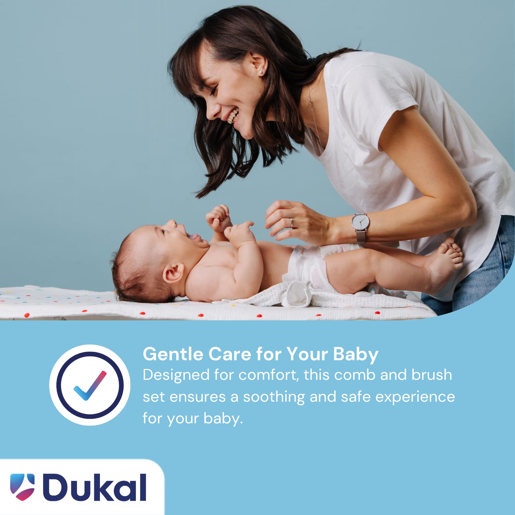 Dukal PCB2 DawnMist ivory comb and brush in use on a newborn