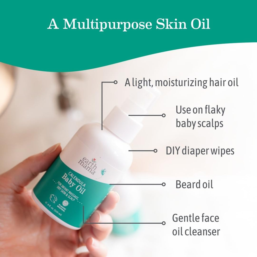 Earth Mama Calendula Baby Oil on hands for gentle newborn massage.