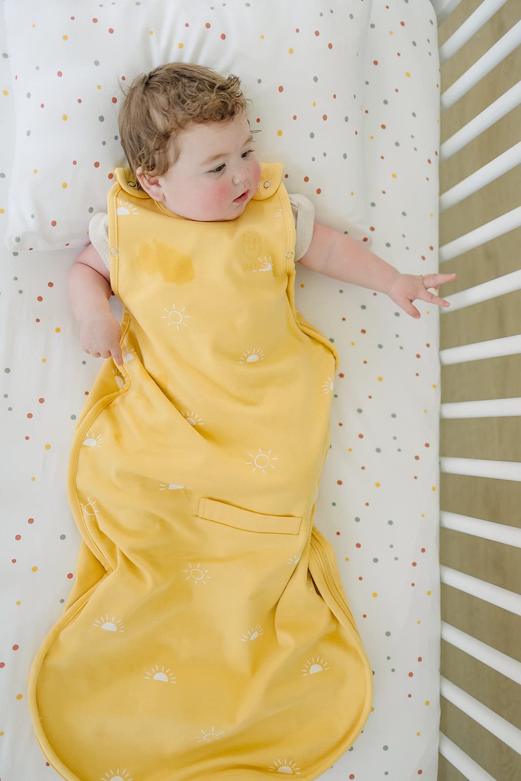 Ecolino dots print crib sheet complements a modern nursery theme with neutral styling.