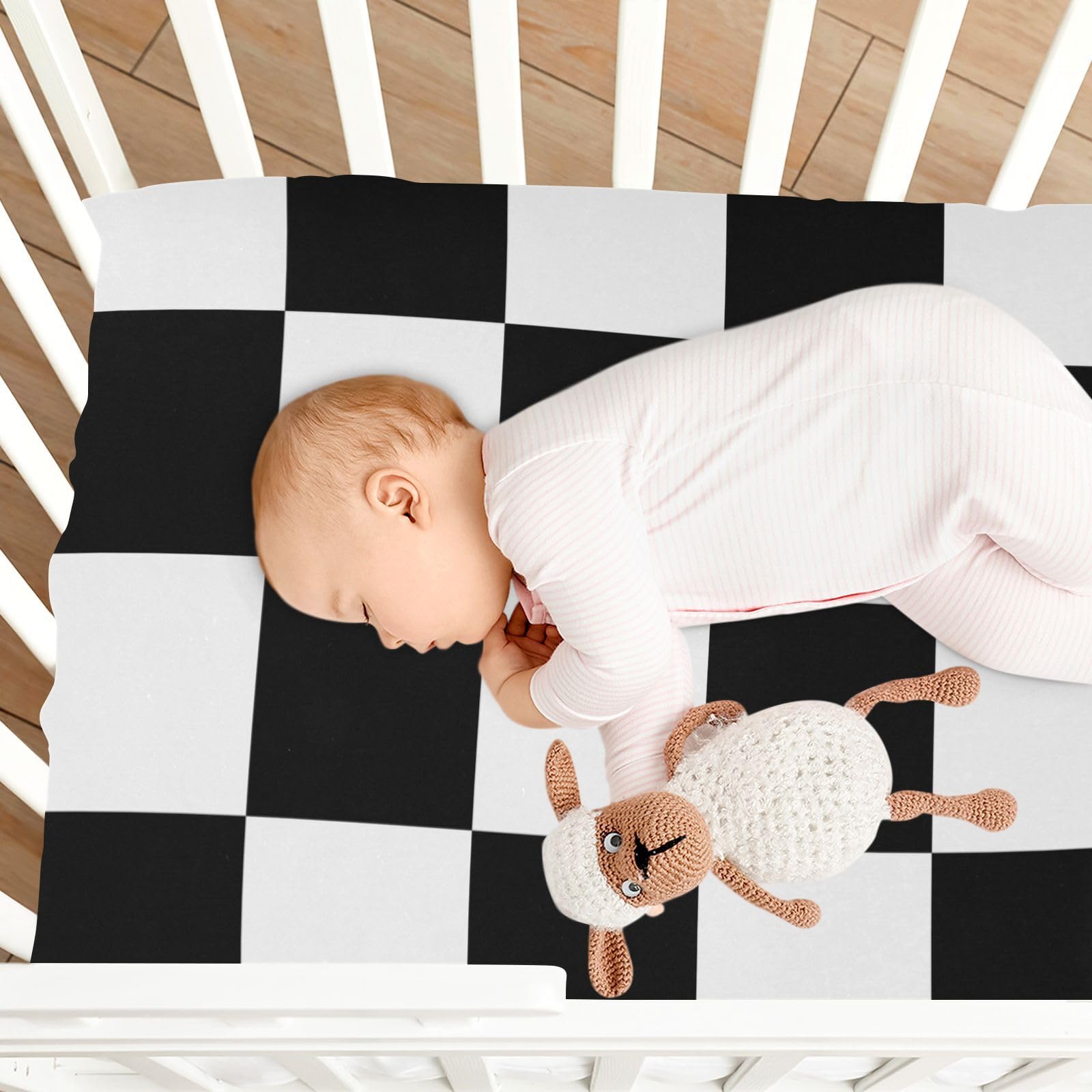 ElliTarr baby sleep scene with checkered crib sheet in use