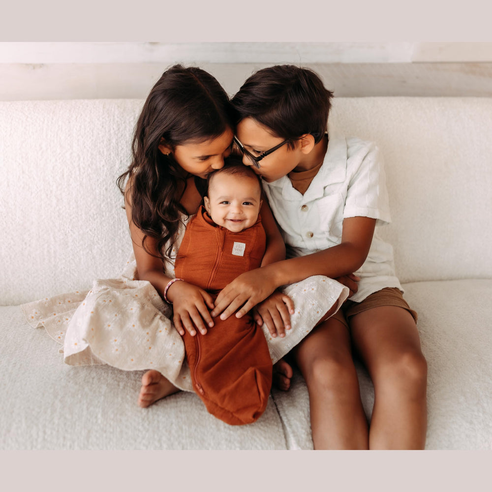 Elovee & Co. rust swaddle care guide shows machine wash and air dry