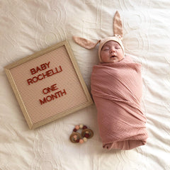 Ely's & Co. Dusty Rose swaddle size tag, 47x47 inches for generous coverage.