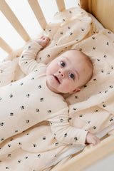 Close-up of ivory fabric with blue cherry pattern from Ely's & Co.