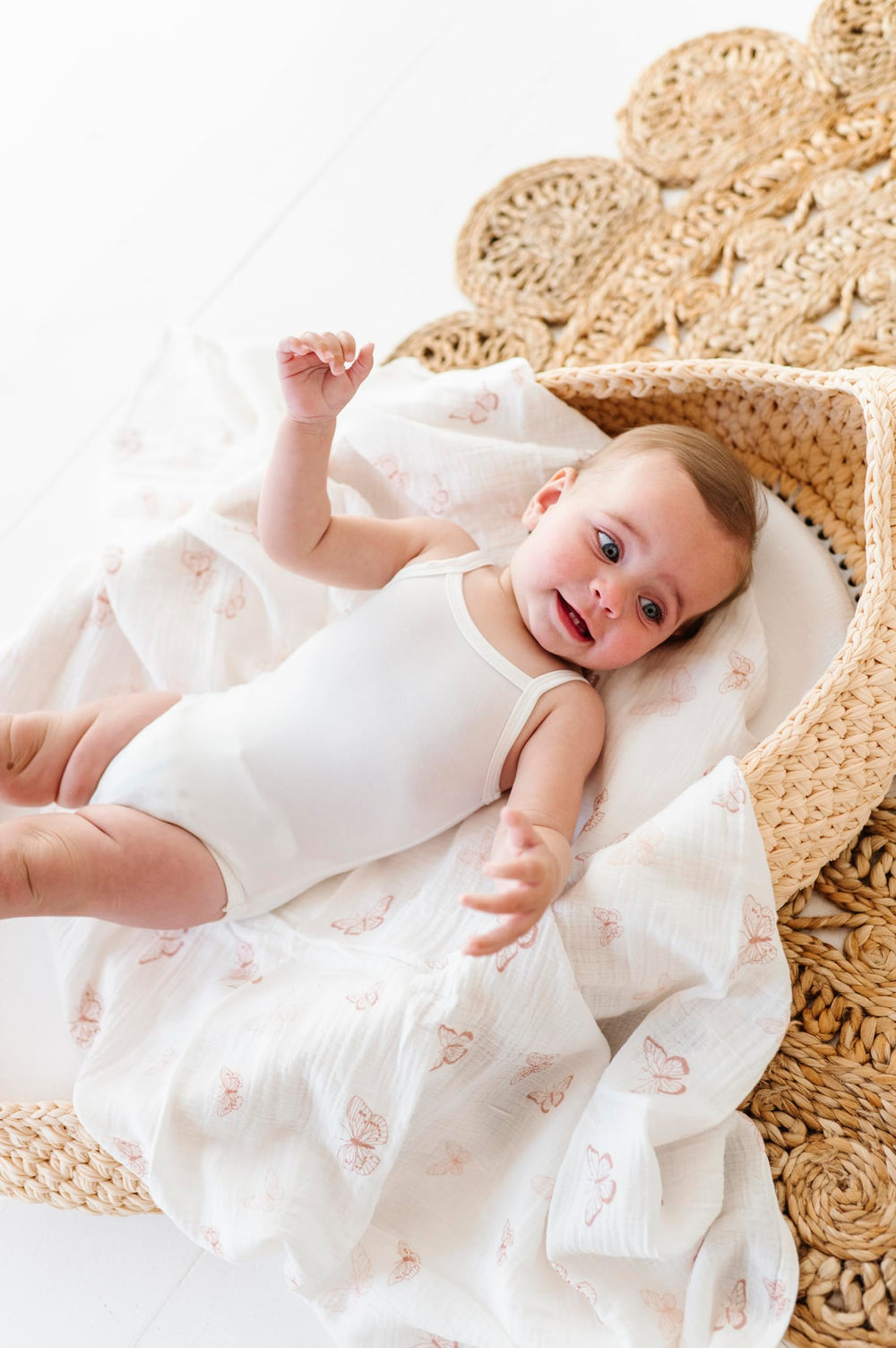Ely's & Co. swaddle blankets shown on a baby, ideal as a stroller cover.