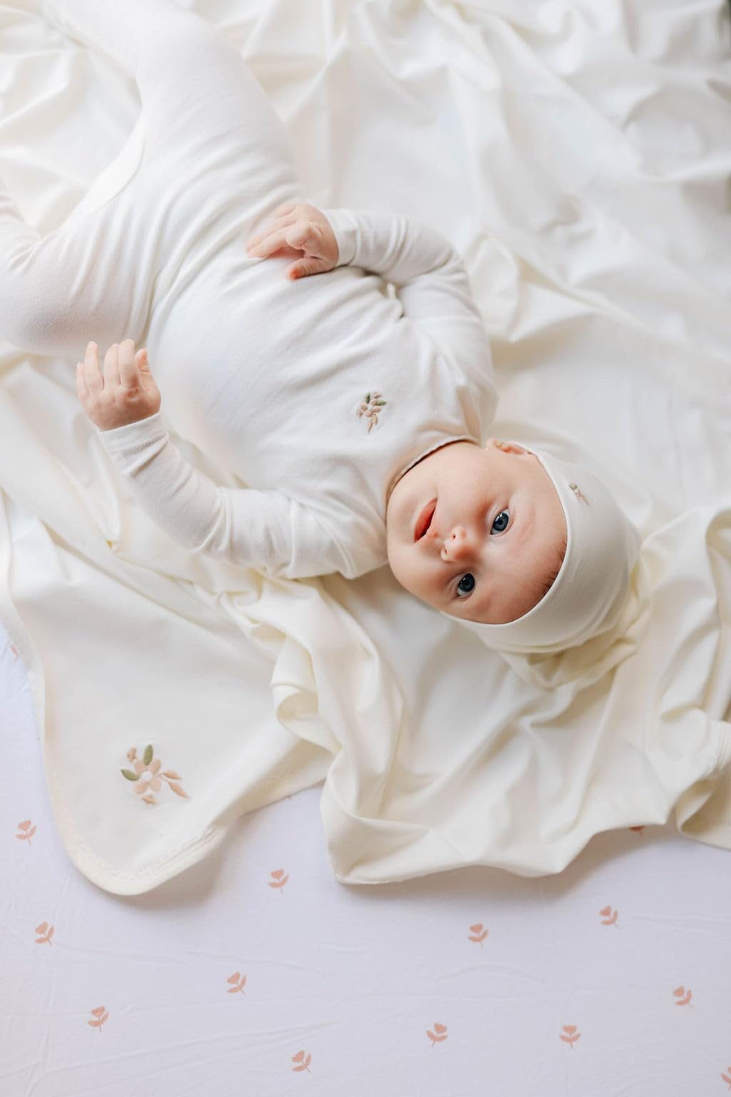 Ely's & Co Pink Tulip pattern closeup showcases gentle nursery charm.