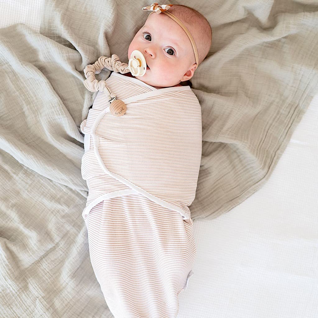 Adjustable wings highlight secure fit for peaceful sleep in Ely's & Co swaddle.