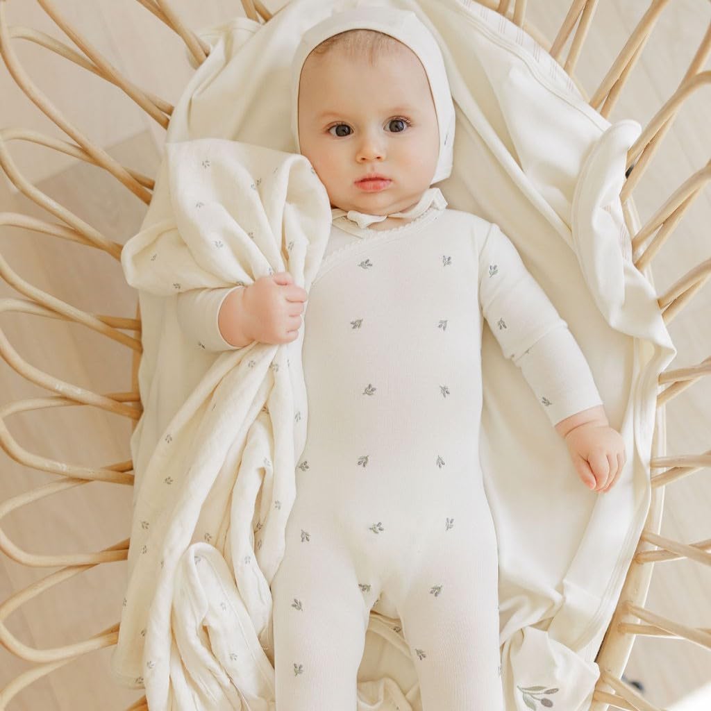 Ely's & Co. swaddle features scallop trim detail for a gentle, stylish design.