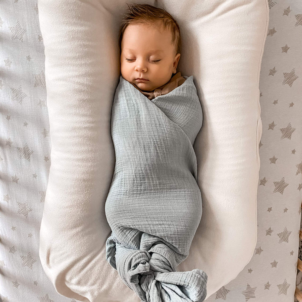 Ely's & Co swaddle as stroller cover on sunny day.