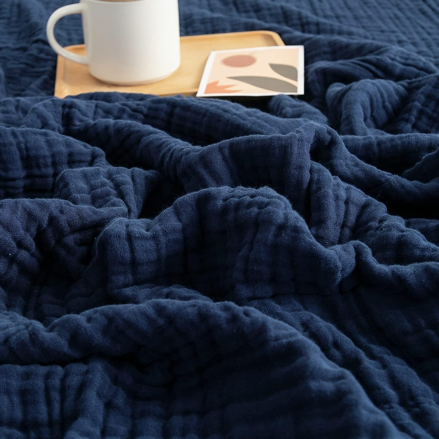 EMME muslin baby blanket navy folded, showing soft fabric and breathable weave