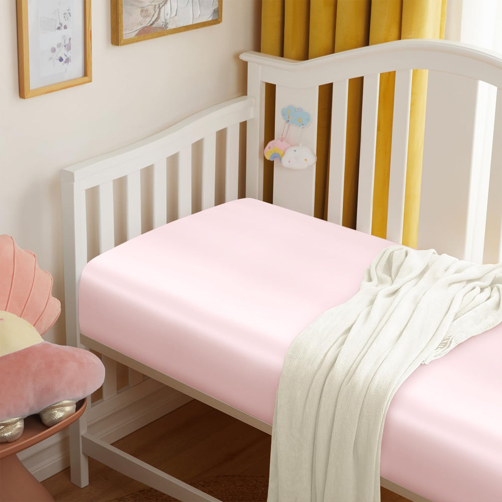Entisn satin crib sheets in baby pink color brighten nurseries and feel gentle
