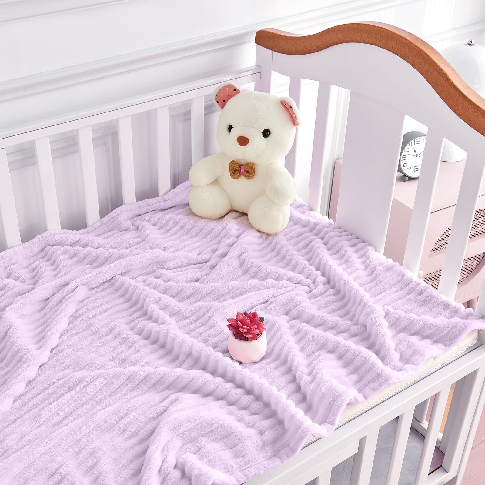 Eonkasp blanket draped over crib highlighting reversible stripes
