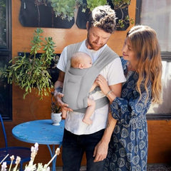 Ergobaby Embrace baby in carrier image highlights closeness and easy setup for new parents.