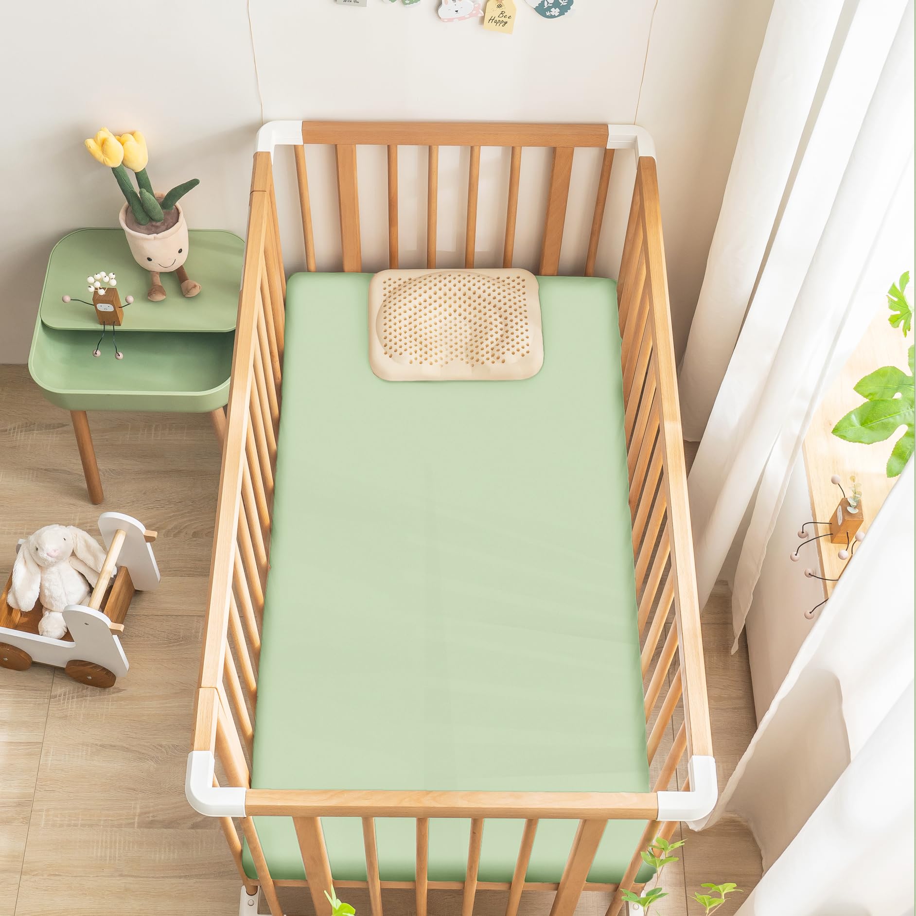 Ersmak satin crib sheet close-up reveals smooth fibers for gentle skin contact.