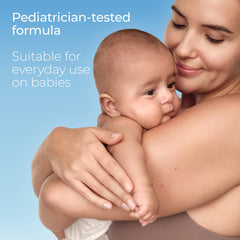 Applying Eucerin Sun Sensitive Mineral Baby Sunscreen SPF 50 to a baby's arm for even coverage