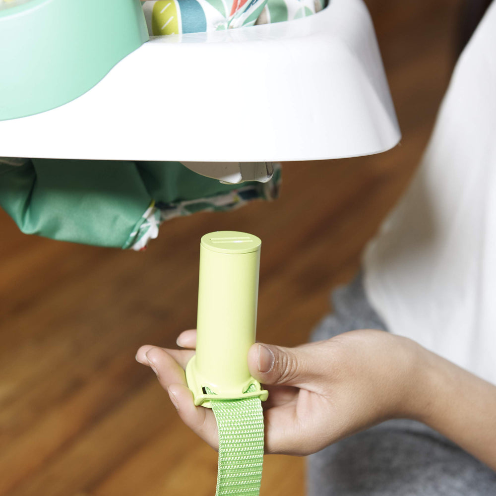 Evenflo Exersaucer Tiny Tropics height-adjustable jumper straps.