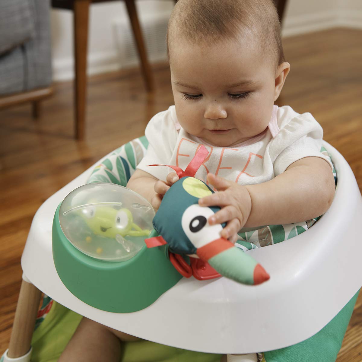 Evenflo Exersaucer Tiny Tropics plush toucan toy for interactive play.