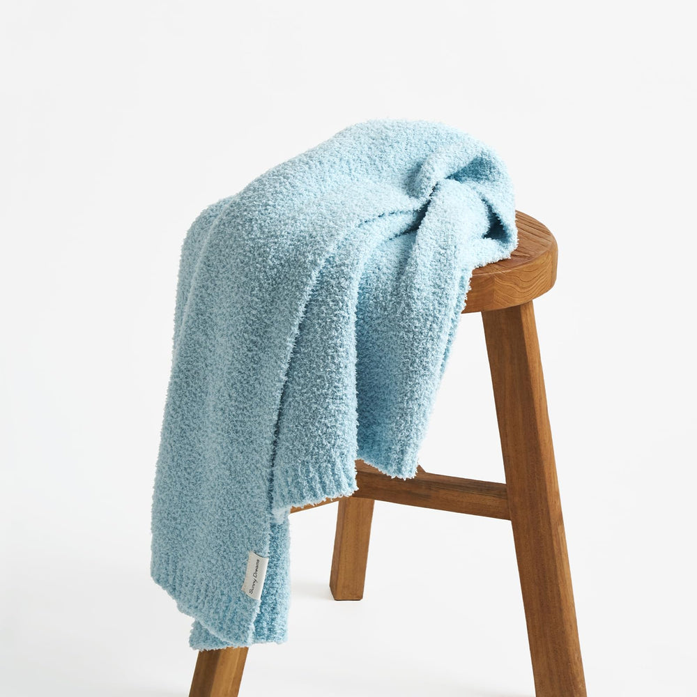 EvergraceHome baby nursery decor blanket placed on chair for styling