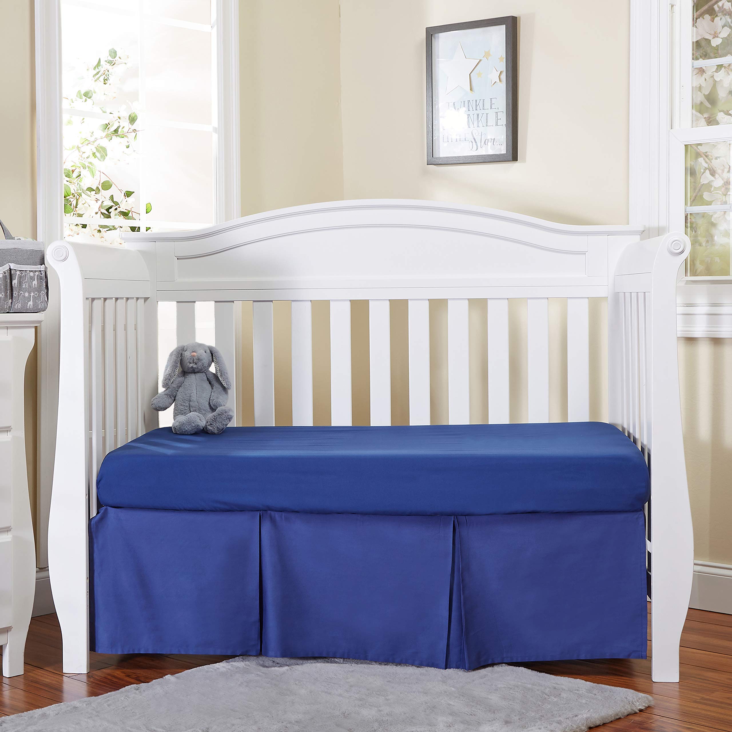 EVERYDAY KIDS navy blue pleated crib skirt hides under-crib storage.