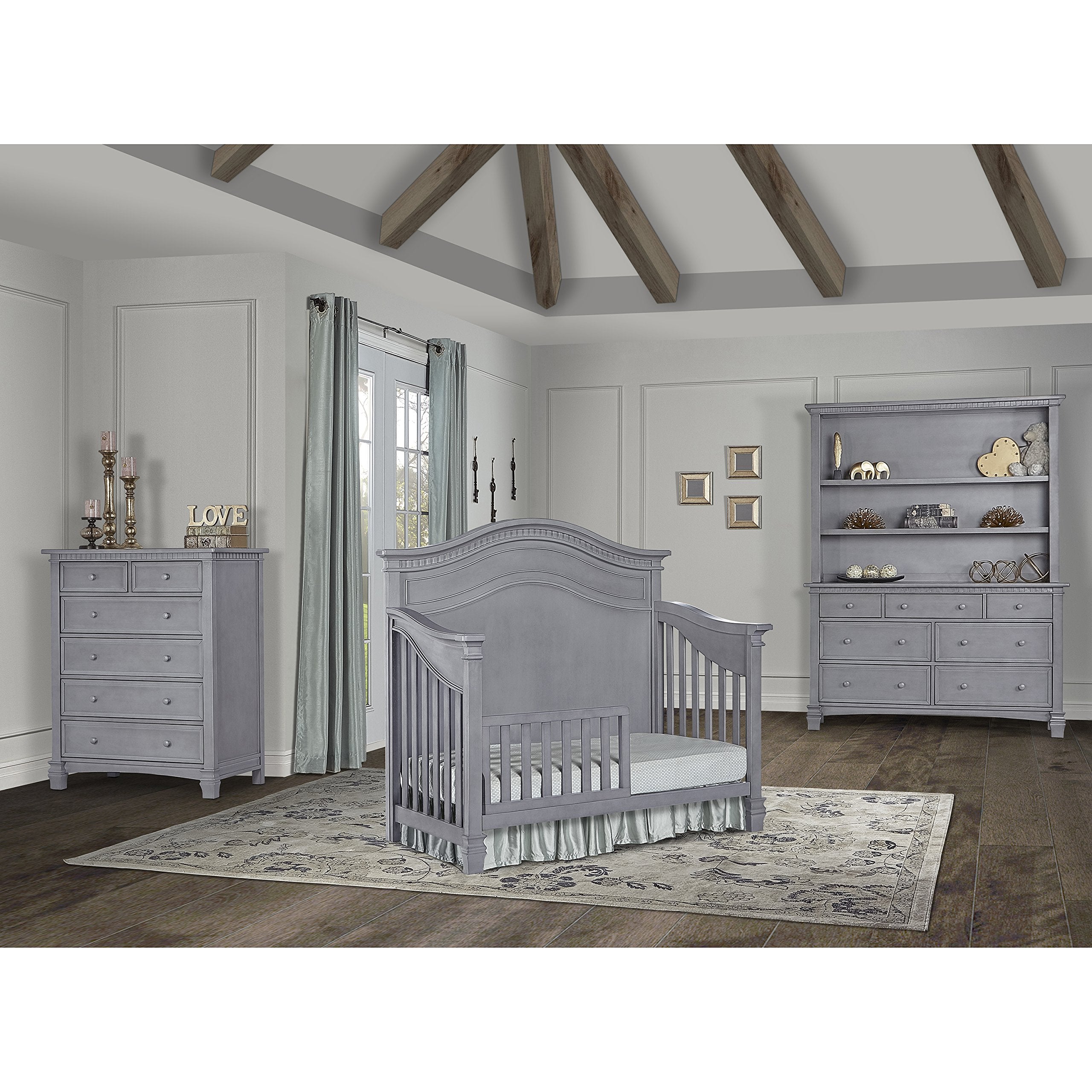 Evolur guard rail on crib shows solid wood durability and easy setup.