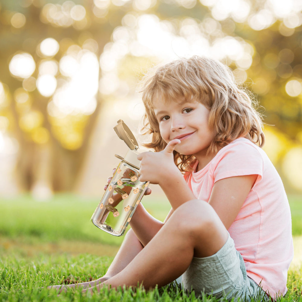 Evorie Tritan kids bottle held by child, lightweight for all-day carry.