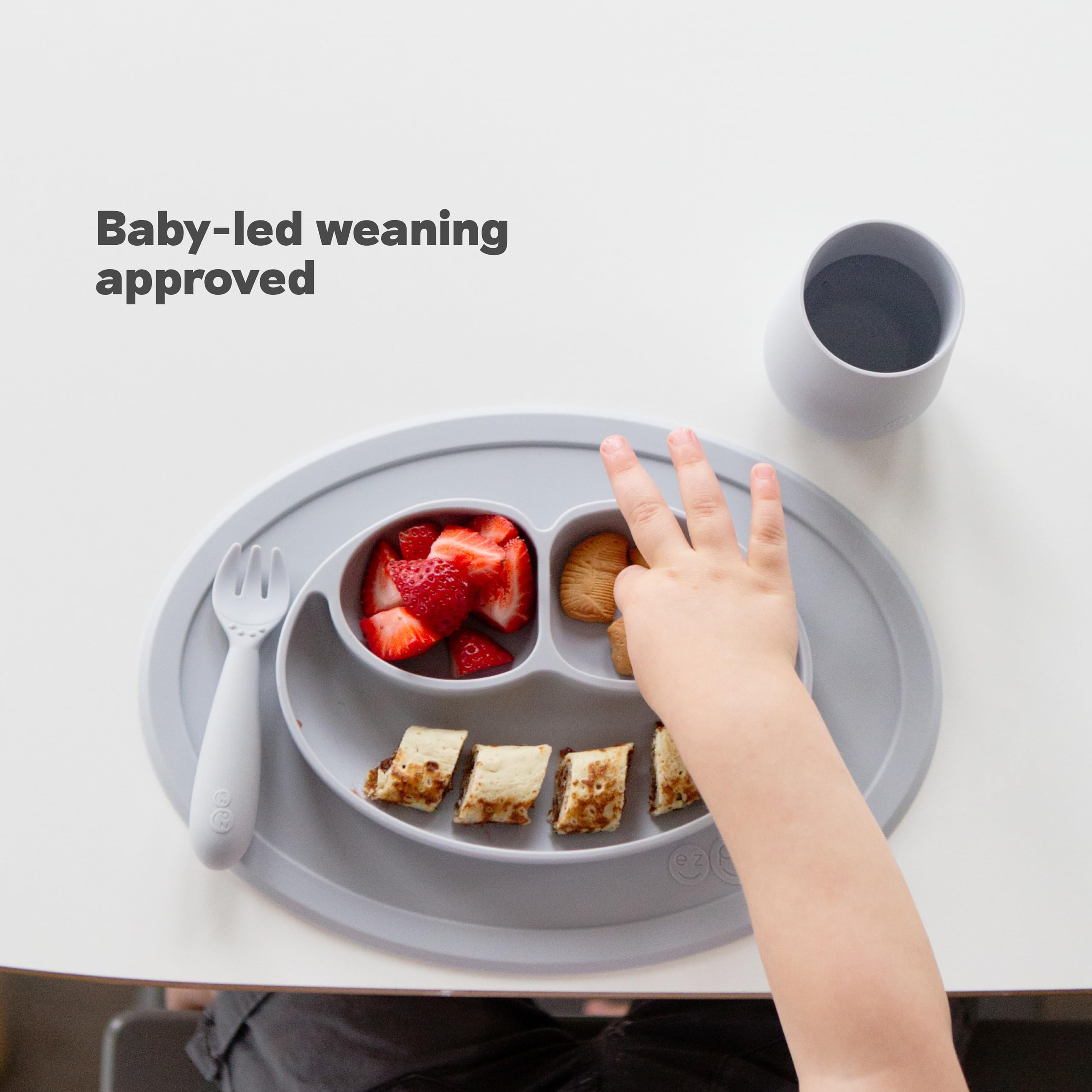 ezpz Mini Mat Sage suction sticks to surfaces for independent feeding
