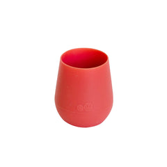 ezpz Tiny Cup Coral weighted base provides topple resistance on a table.