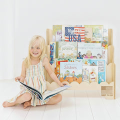 Fable Twig wooden kids bookshelf with scalloped edges keeps picture books within reach.