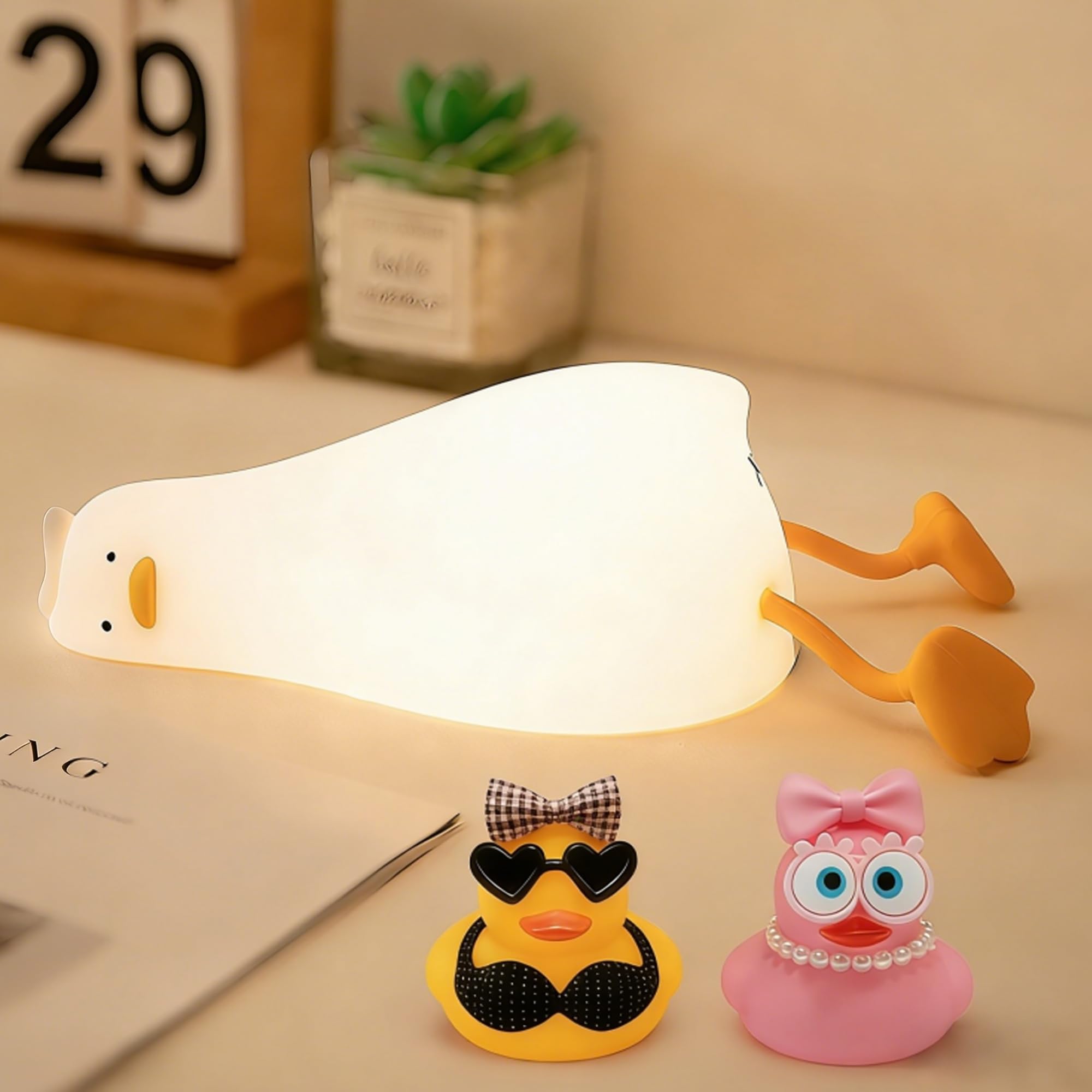 FAMIDUO lying-flat duck night light glows softly for calming bedside ambiance.