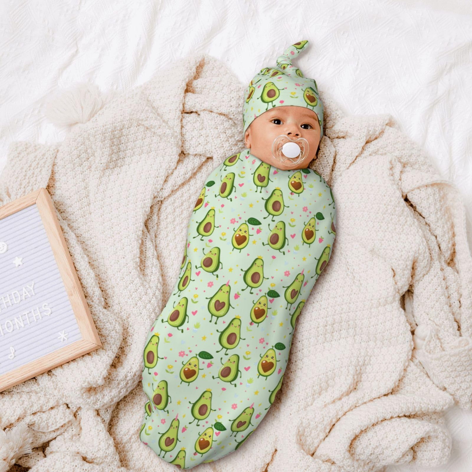 Figtihw Avocado Swaddle Blanket on baby, showcasing unisex look.