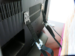 FitFabHome metal plates and buckle strap provide sturdy anti-tip support for TVs.