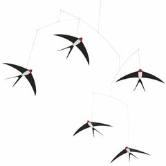 Flensted 5 swallows mobile hanging over bed for calming ambience.