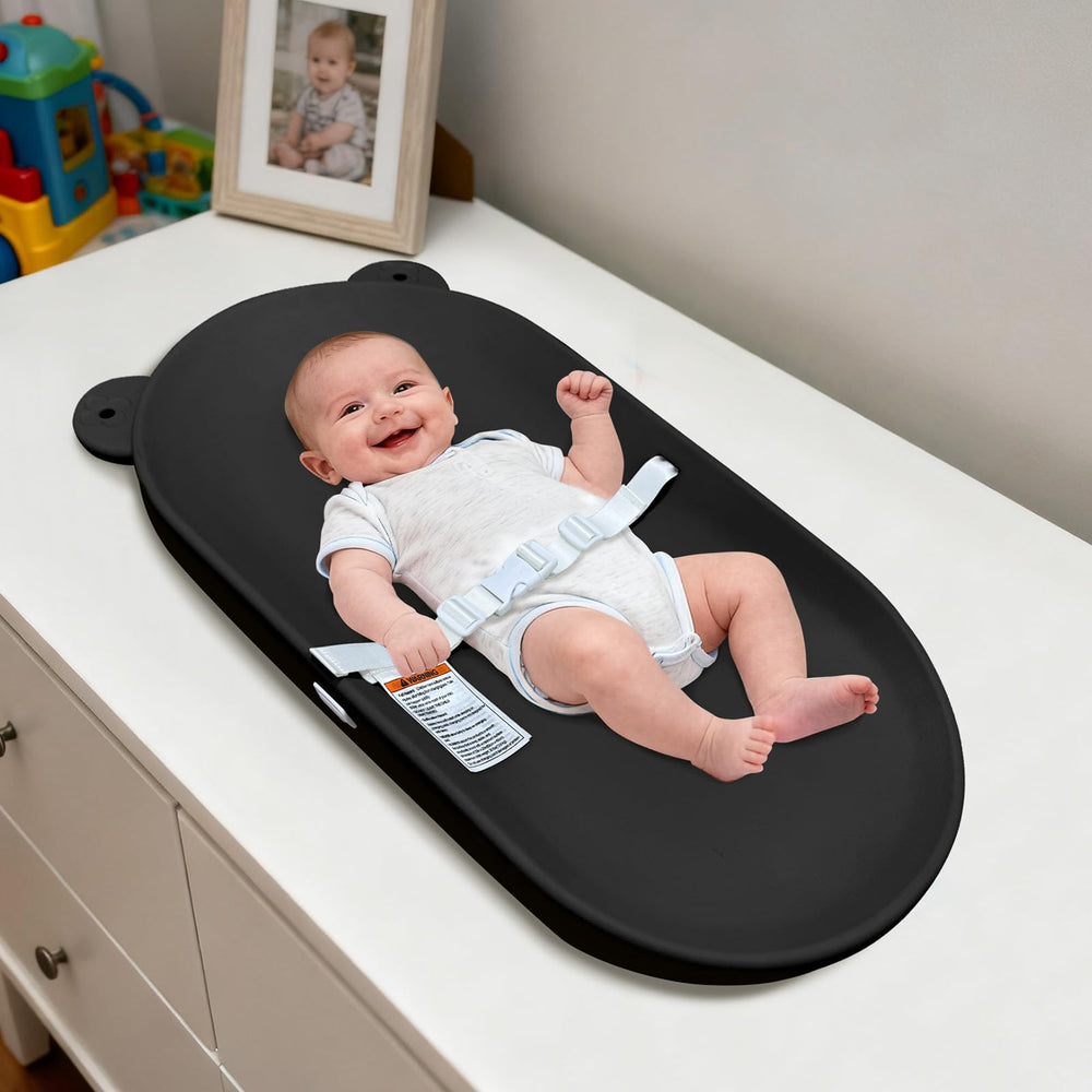 FLEUFAB changing pad with strap on sturdy table for secure diaper changes