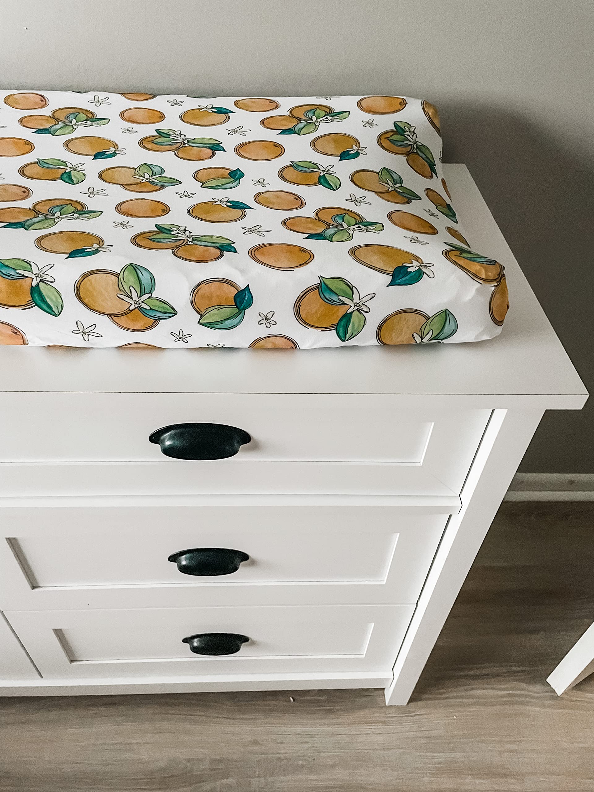 Florida Kid Co. Orange Blossom cover highlights snug elastic fit for secure diaper changes.