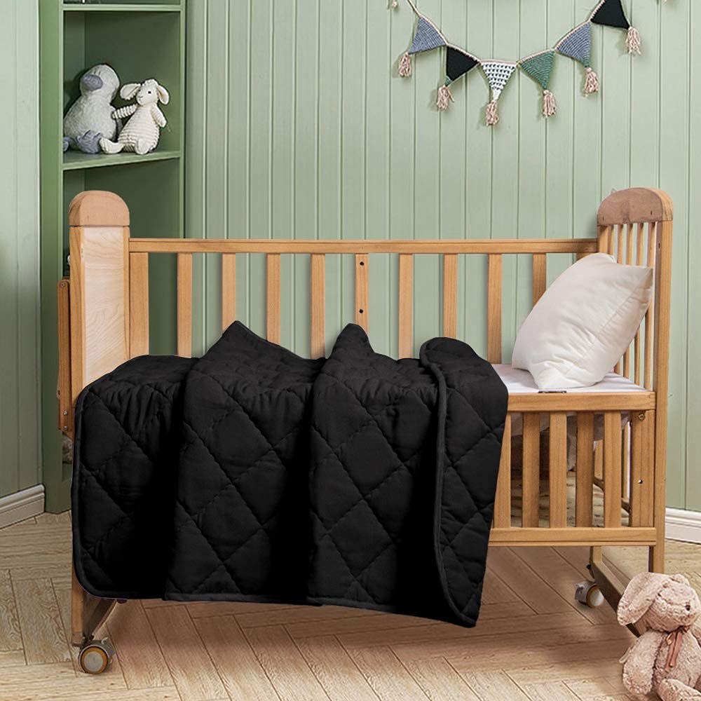 FLXXIE 39x47 inch quilt laid on crib, versatile design.