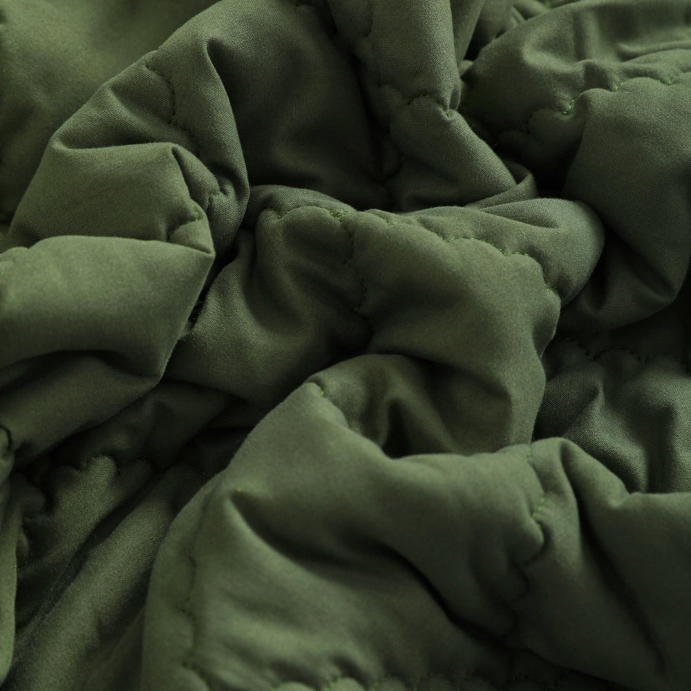 FLXXIE olive comforter spread on crib or bed for cozy, decorative styling
