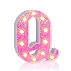 Foaky pink light up letters on a shelf add playful shimmer to any room.