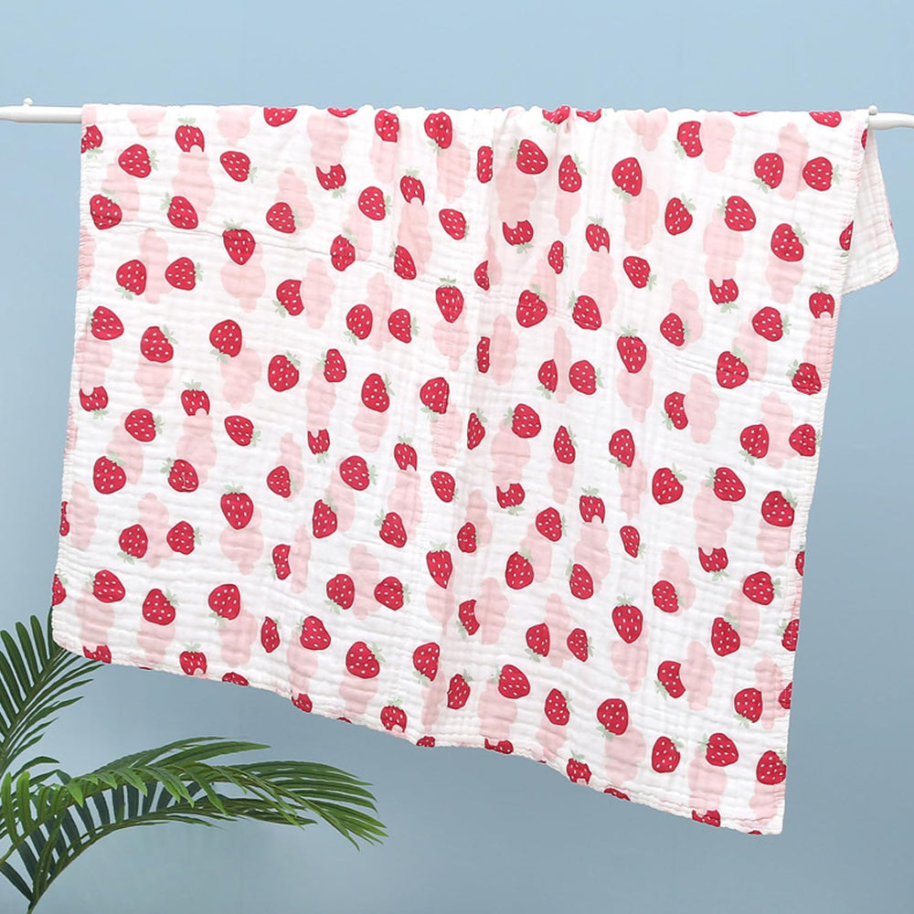 FOMAISELF Strawberry muslin blanket used as a newborn swaddle for comfort