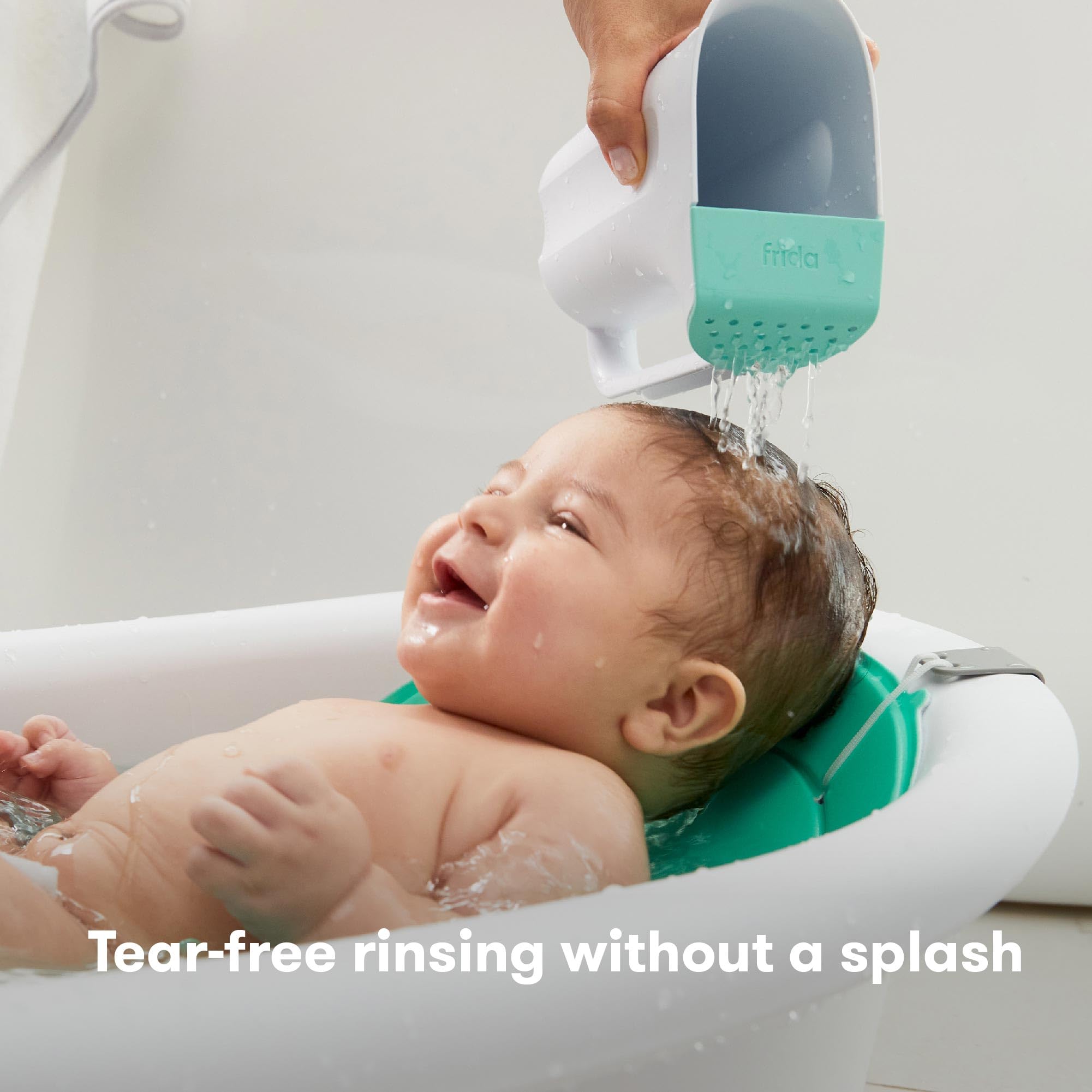 Frida Baby Control The Flow Rinser showing dual rain shower for newborn rinse.