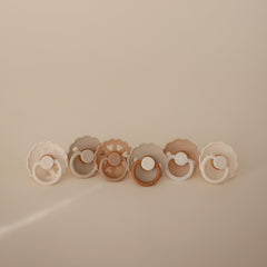 FRIGG Cinnamon Charm pacifier back view demonstrates secure handle for easy grasp.