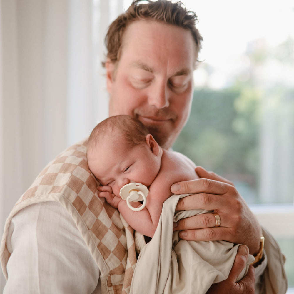 FRIGG pacifier air holes detail offers breathability for sensitive gums.