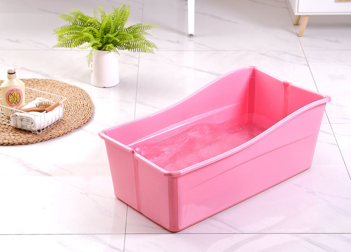 Ganen Baby Bath Tub Portable Pink folded for compact storage and travel.