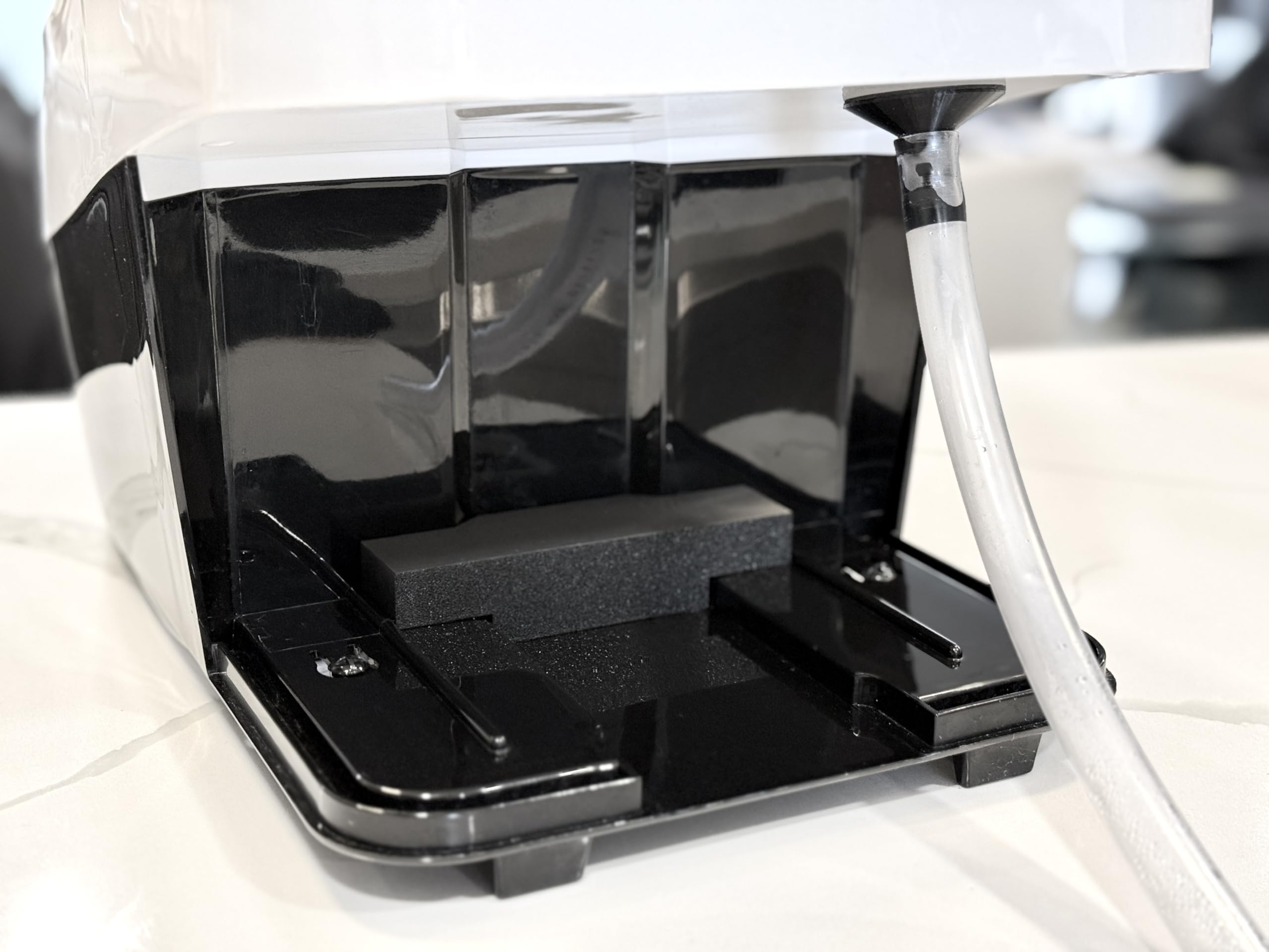 Generic Bottle Washer Pro drainage setup shown beside the sink.