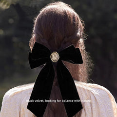 Generic velvet bow detail highlights satin-edged ribbon and secure clip